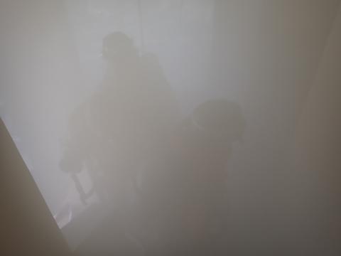 訓練では、建物内を煙を充満させて視界の悪い環境を再現しました。その中を消防隊が要救助者を検索しています。